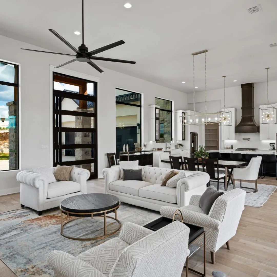 Living room with barn doors and hardwood flooring.