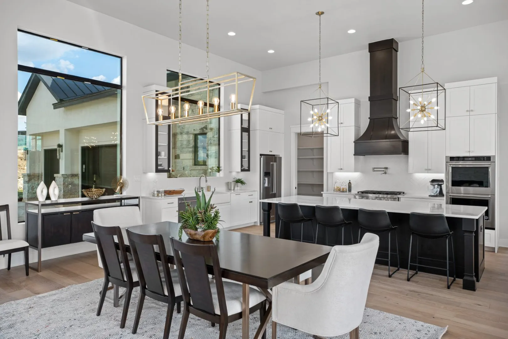 A beautiful updated modern kitchen by T.A. French Home Builders with a bar and dining area that is open concept.