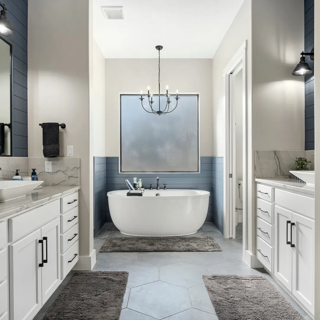 Granite counter sink with updated features, a fireplace in the background and wooden shelving.